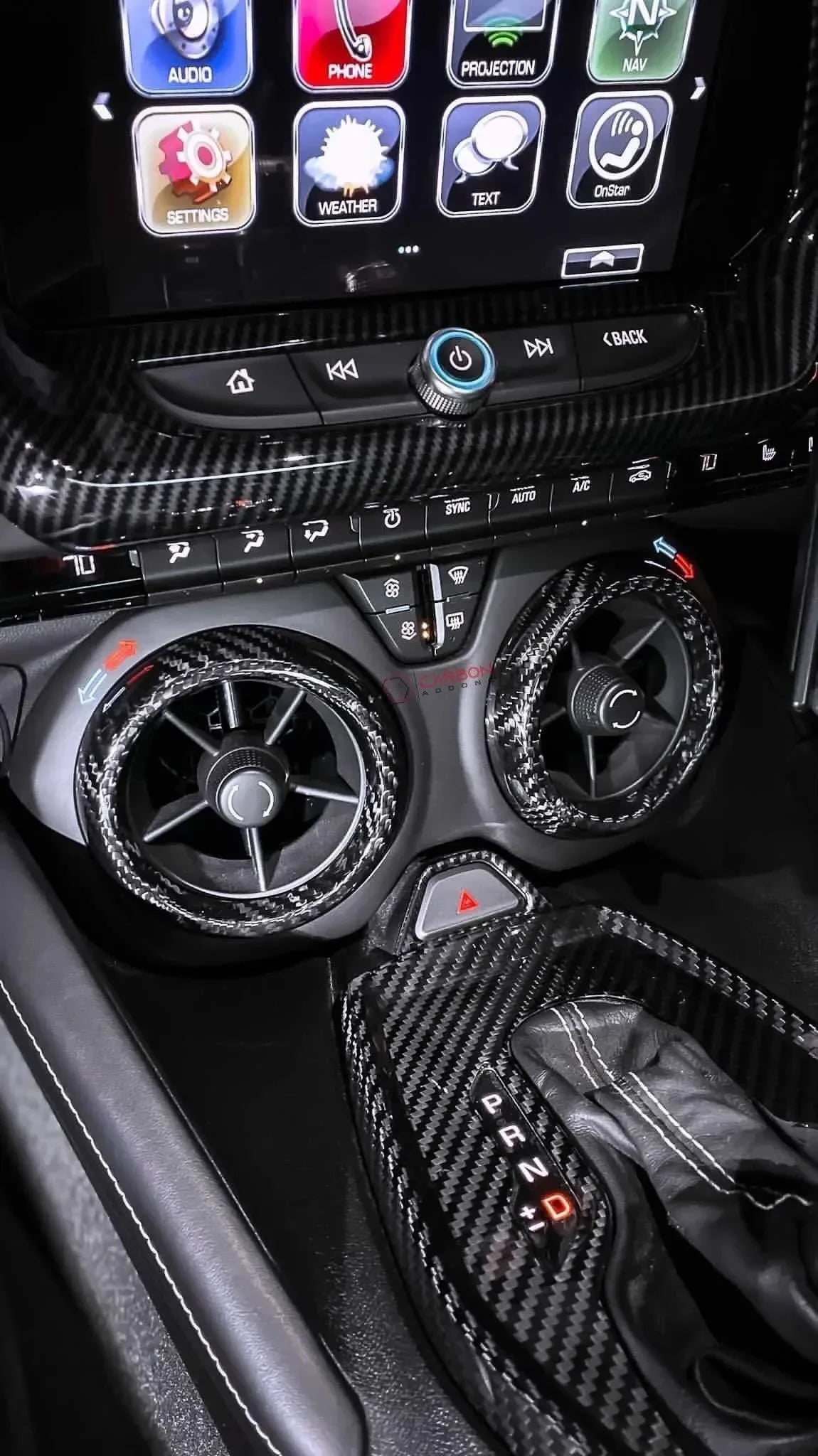 Real carbon fiber interior trim for car dashboard, air vents, and gear shifter with glossy weave finish
