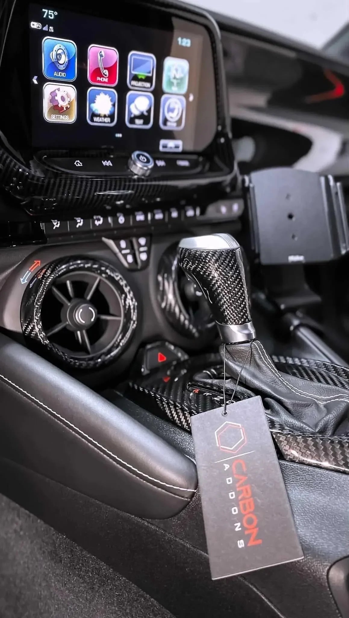 Carbon fiber interior trim kit with gear shifter and vent accents for American muscle cars