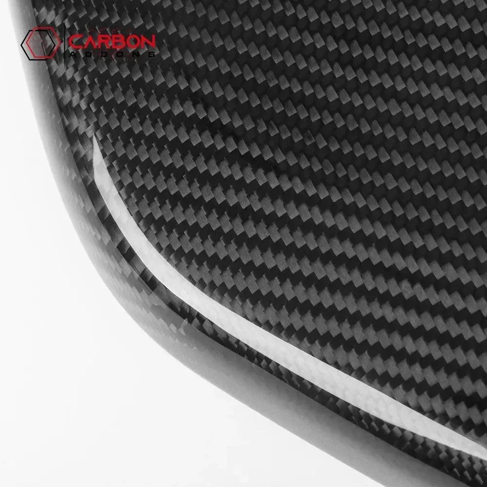 Real carbon fiber automotive part with glossy weave pattern and white accent stripe