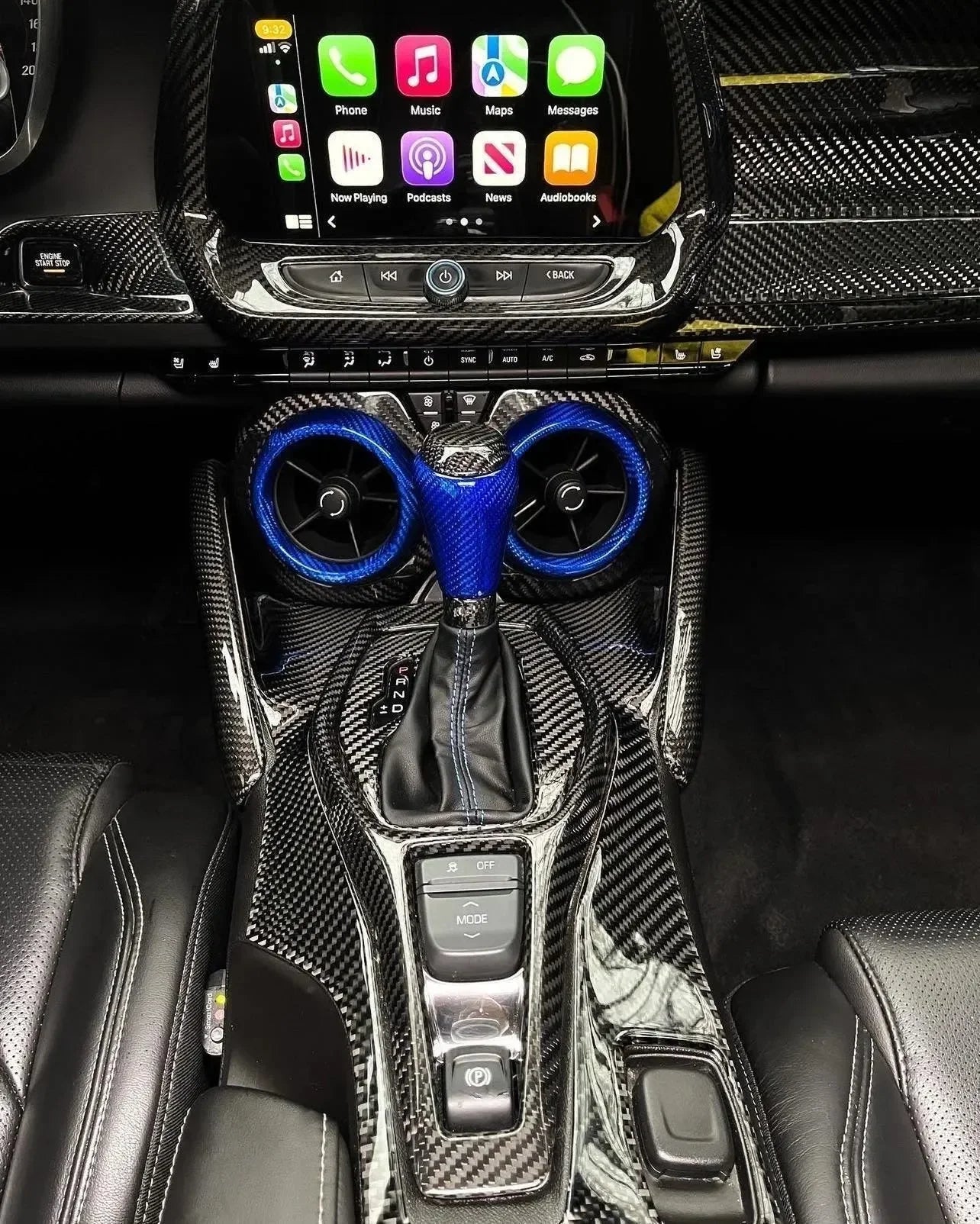 Carbon fiber interior with blue-accented gear shifter and air vents for American performance vehicles