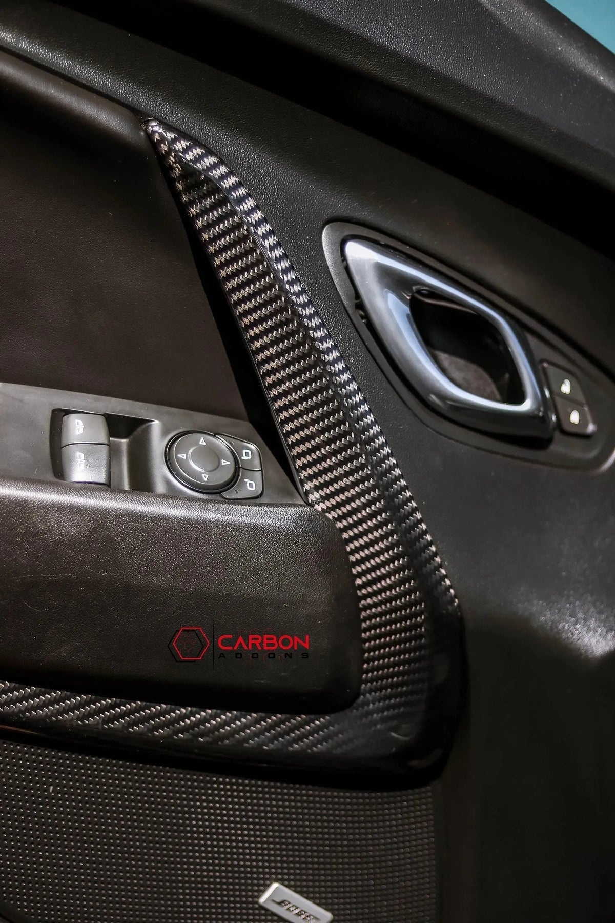 Real carbon fiber interior trim for car door panel with window controls and sleek black finish