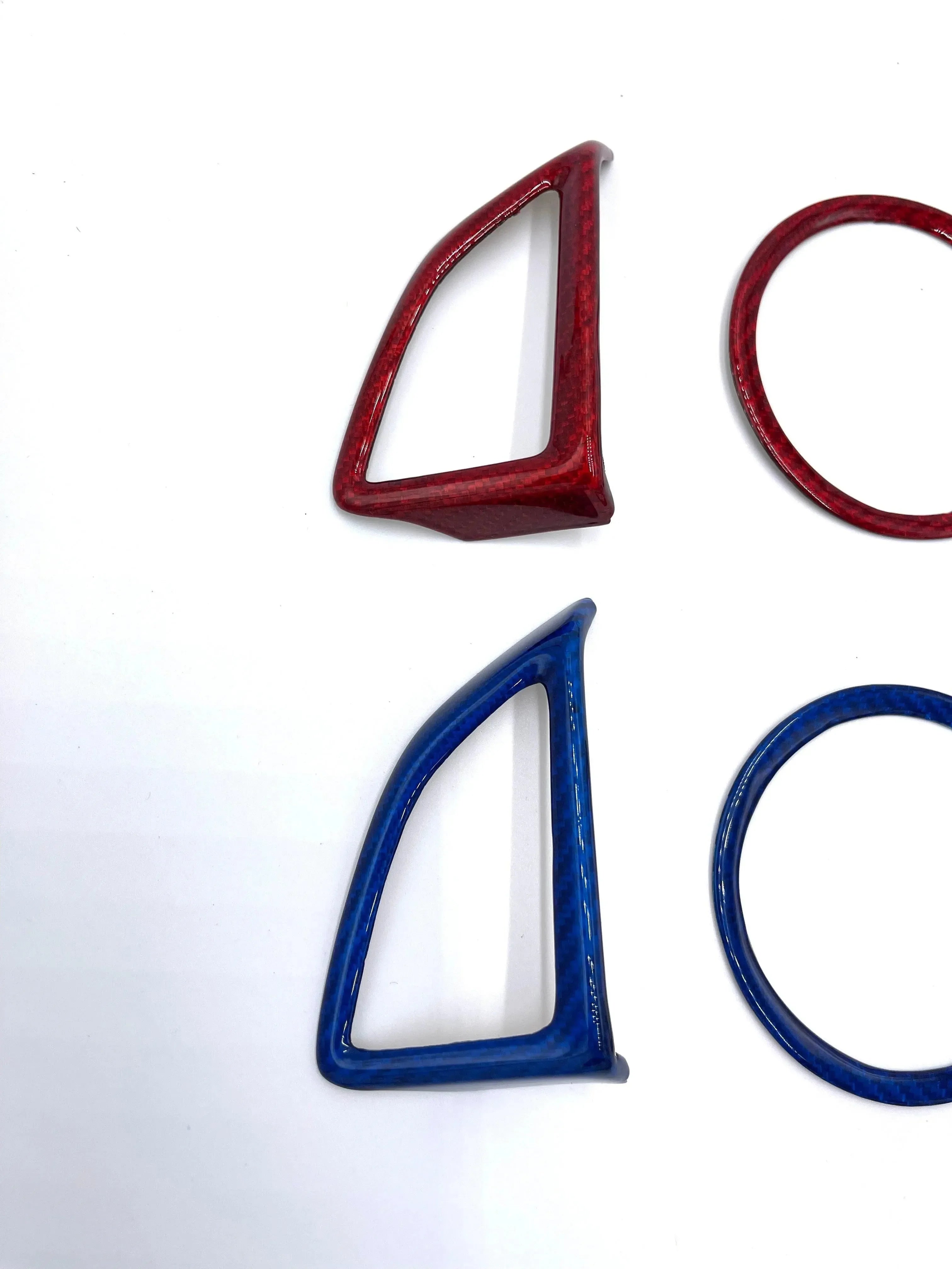 Red and blue carbon fiber trim pieces for car interiors and exteriors