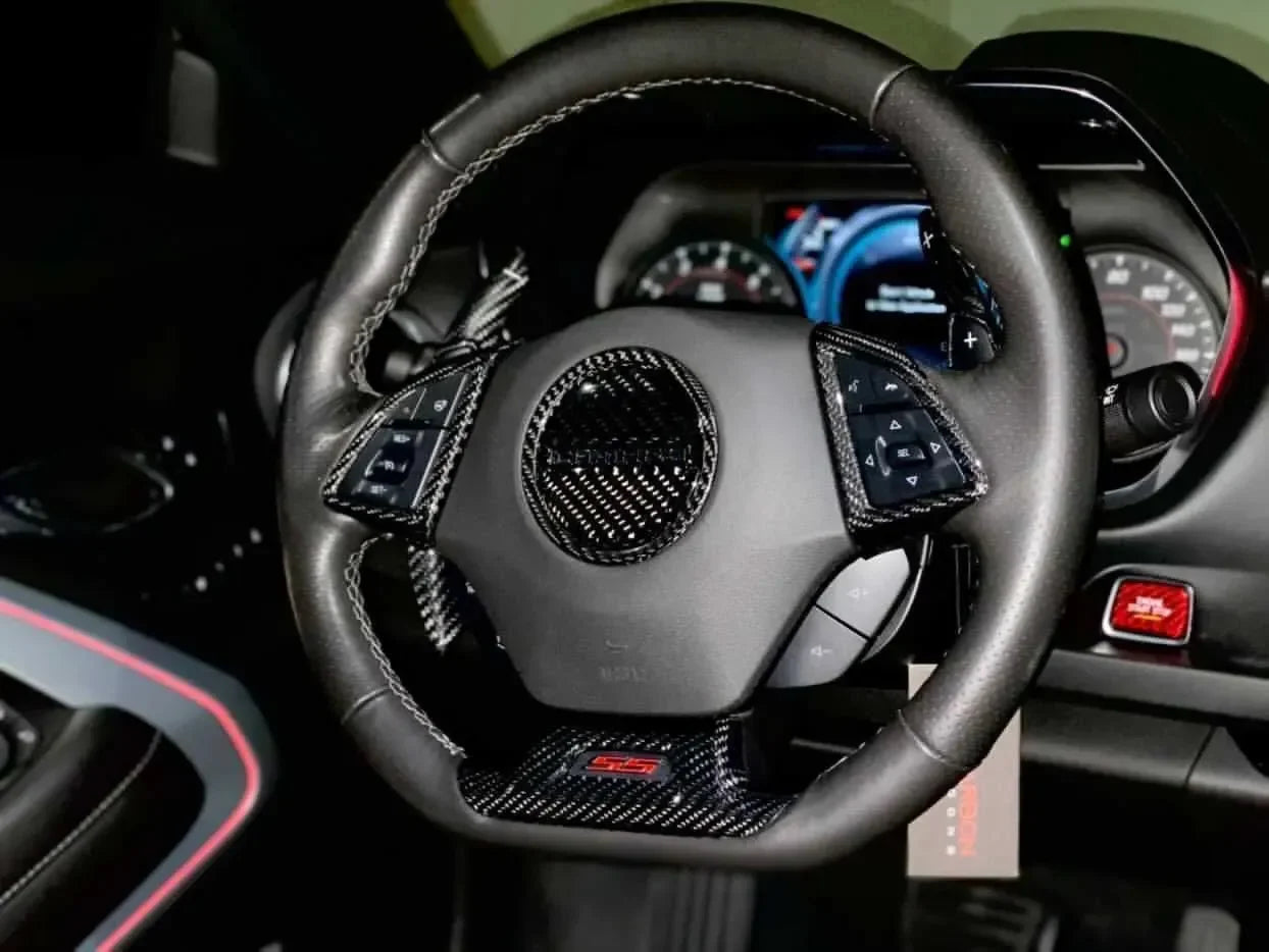 Real carbon fiber steering wheel trim for Chevy Camaro SS, featuring sleek black weave and red stitching accents.