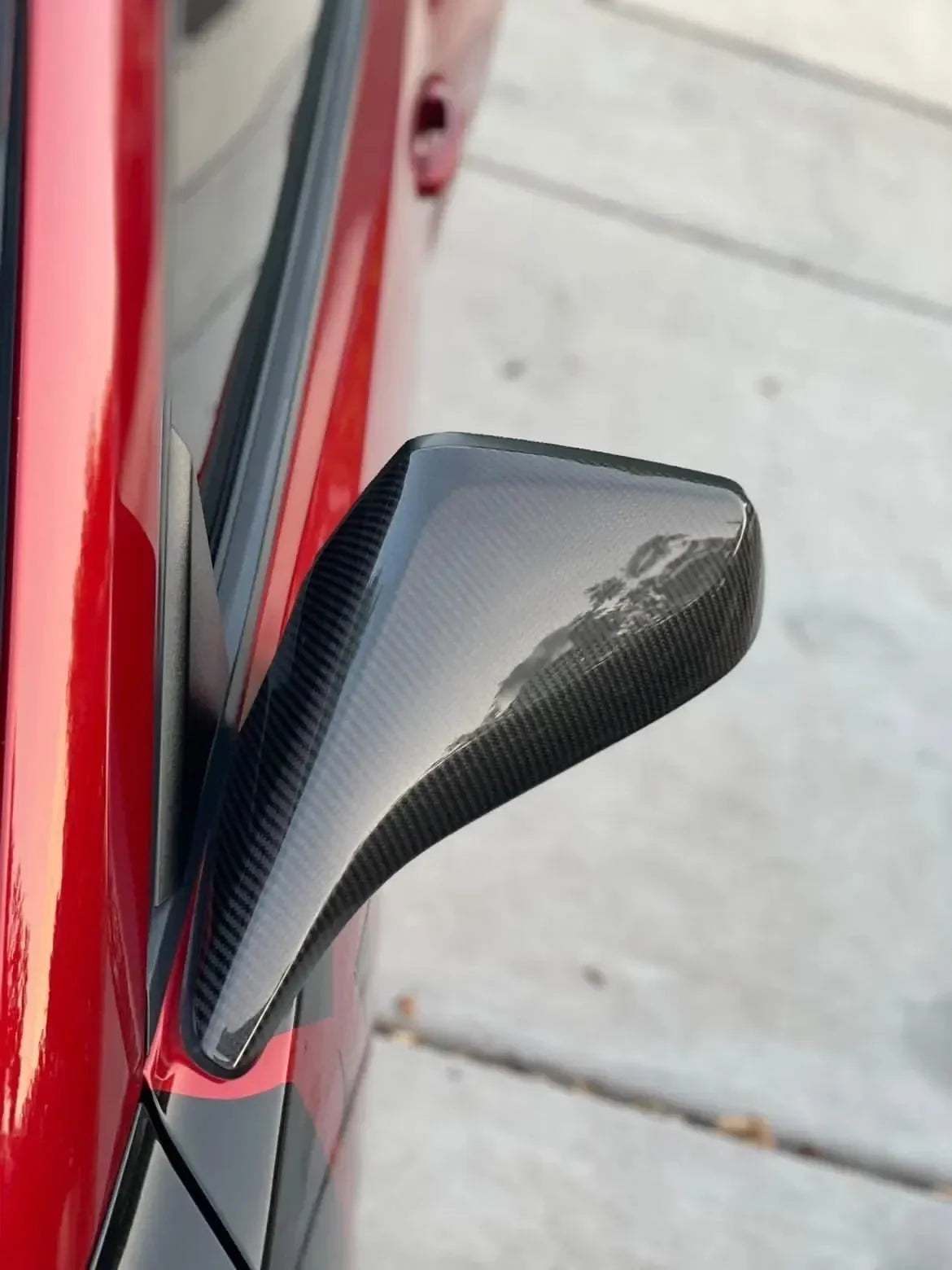 Real carbon fiber side mirror cover for red sports car, sleek glossy finish, fits American muscle vehicles