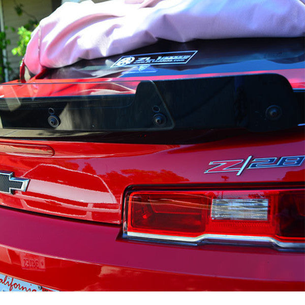 Red car with 'Z28' badge on a blurred background