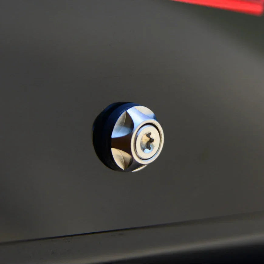 Close-up of a metallic screw on a dark surface