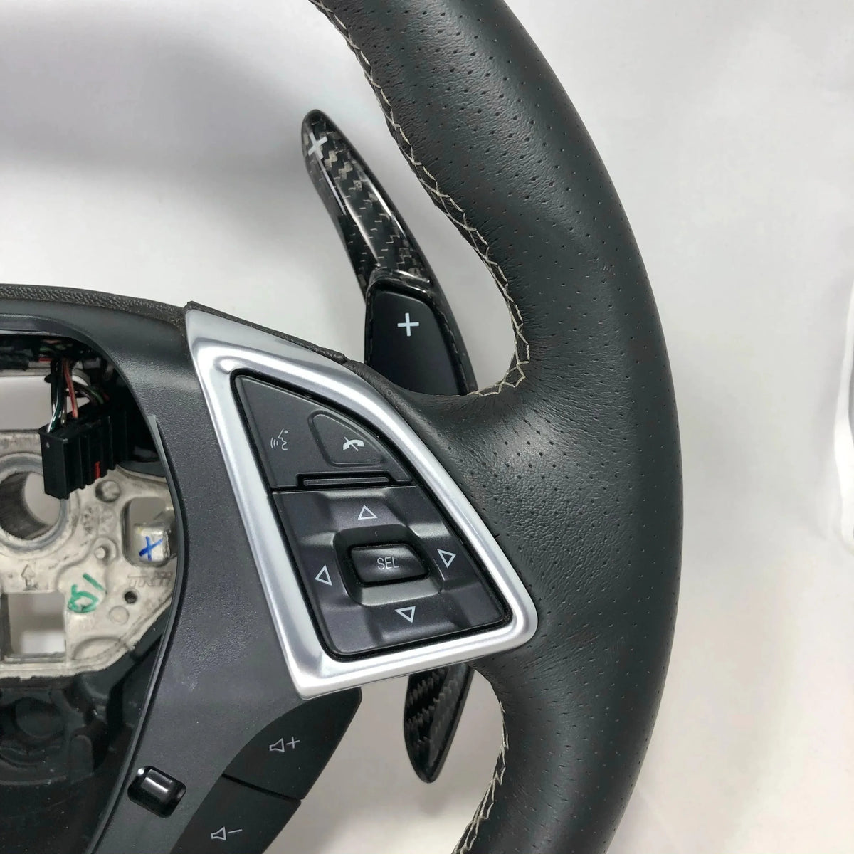 Carbon fiber steering wheel paddle shifter with perforated leather wrap and control buttons