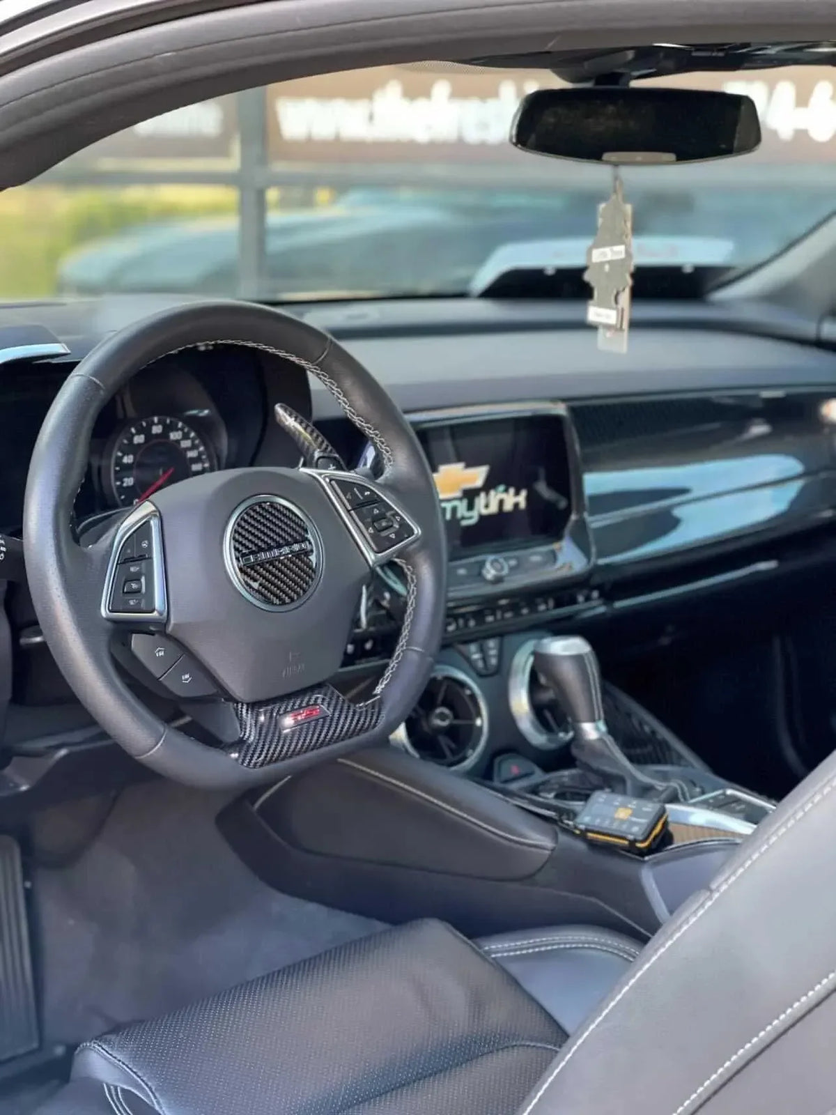 Chevy Camaro interior with real carbon fiber steering wheel and dashboard accents for performance styling