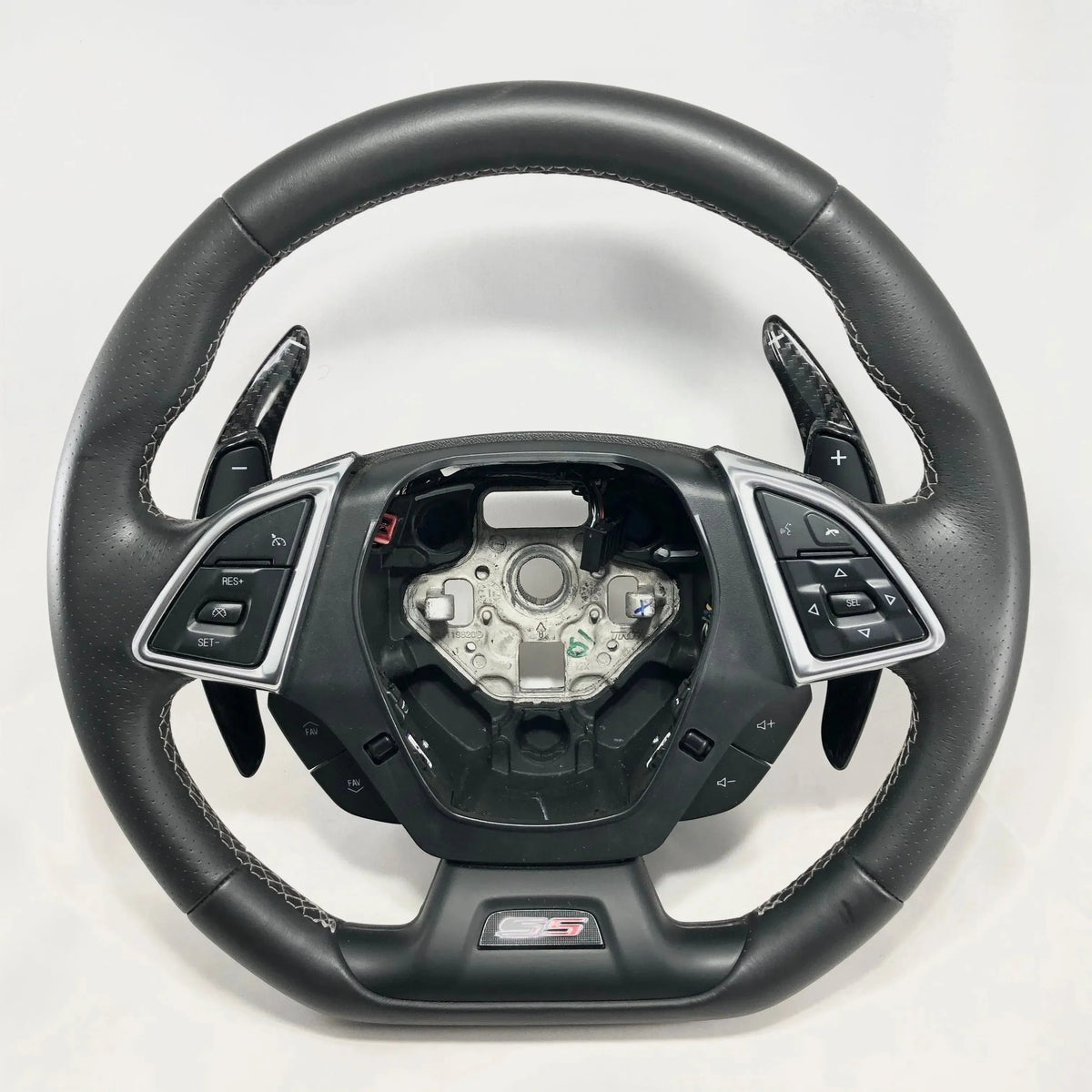 Carbon fiber steering wheel with GS badge, leather grip, and paddle shifters for performance vehicles