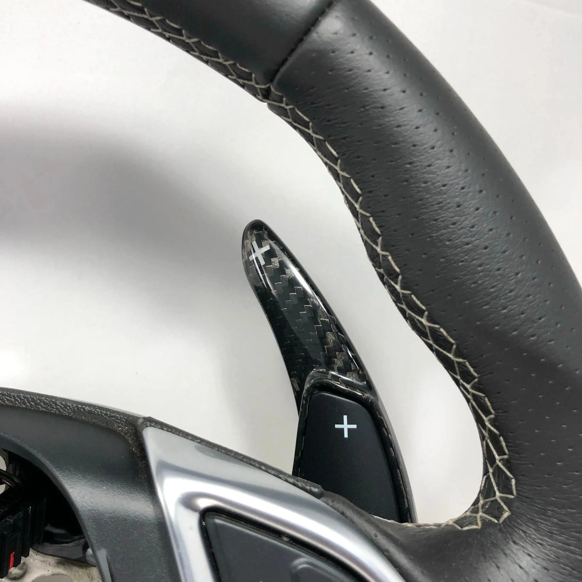 Carbon fiber steering wheel paddle shifter with perforated leather grip