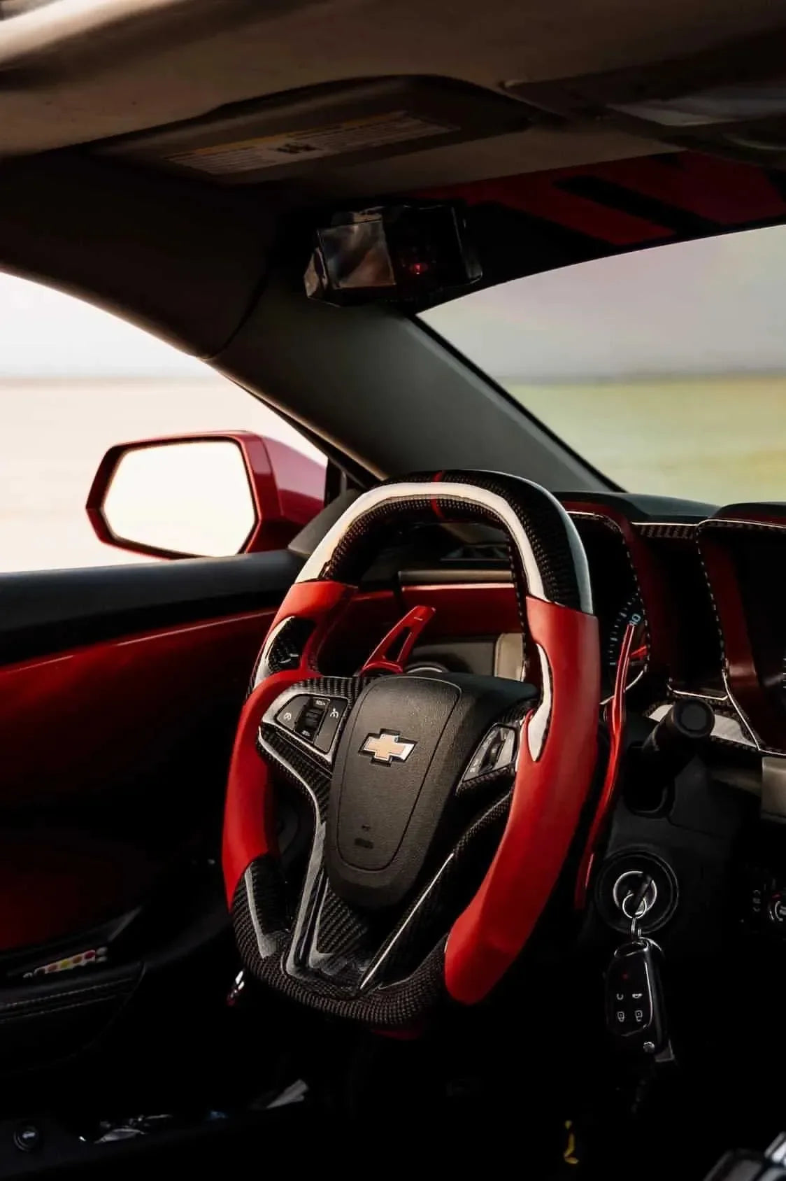 Chevy Camaro interior with real carbon fiber steering wheel and red accents