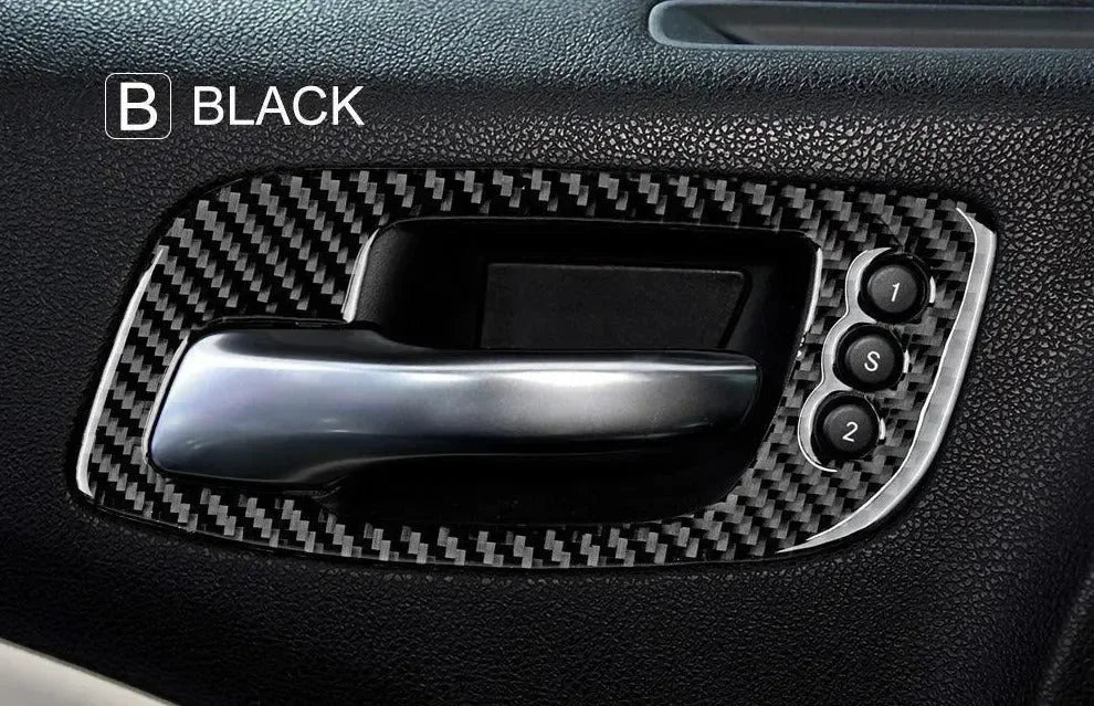 Black carbon fiber interior door panel trim with glossy handle and control buttons