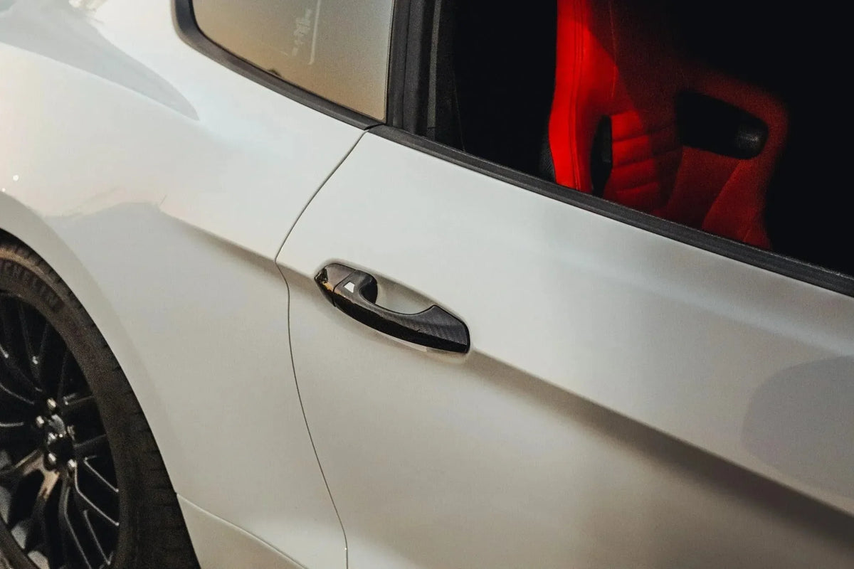 White car with carbon fiber door handle and red interior seat