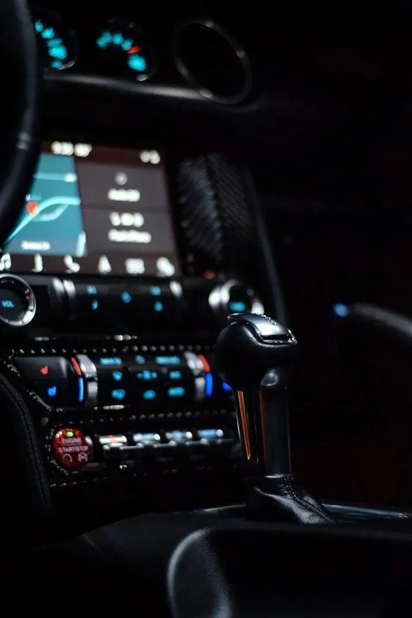 Carbon fiber interior upgrade with gear shifter and illuminated controls for American performance vehicles