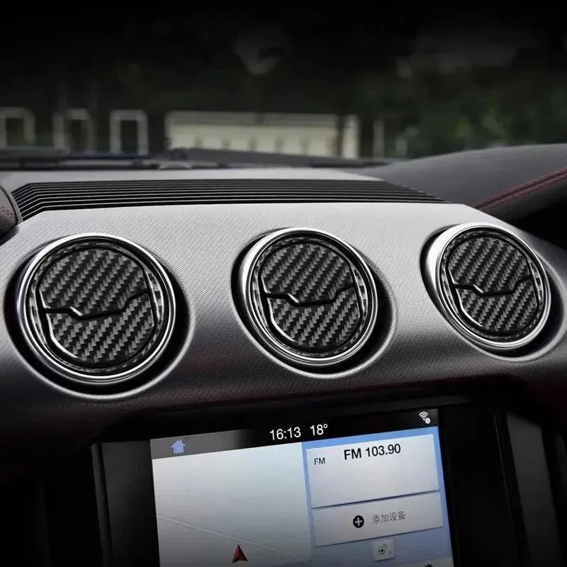 Real carbon fiber air vent covers for Ford Mustang interior, sleek black weave design with chrome trim