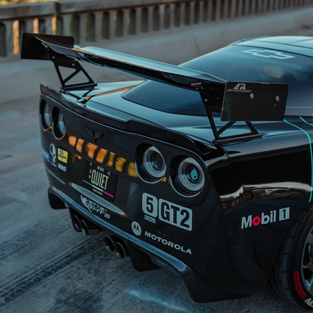 Black race car with visible branding on a track