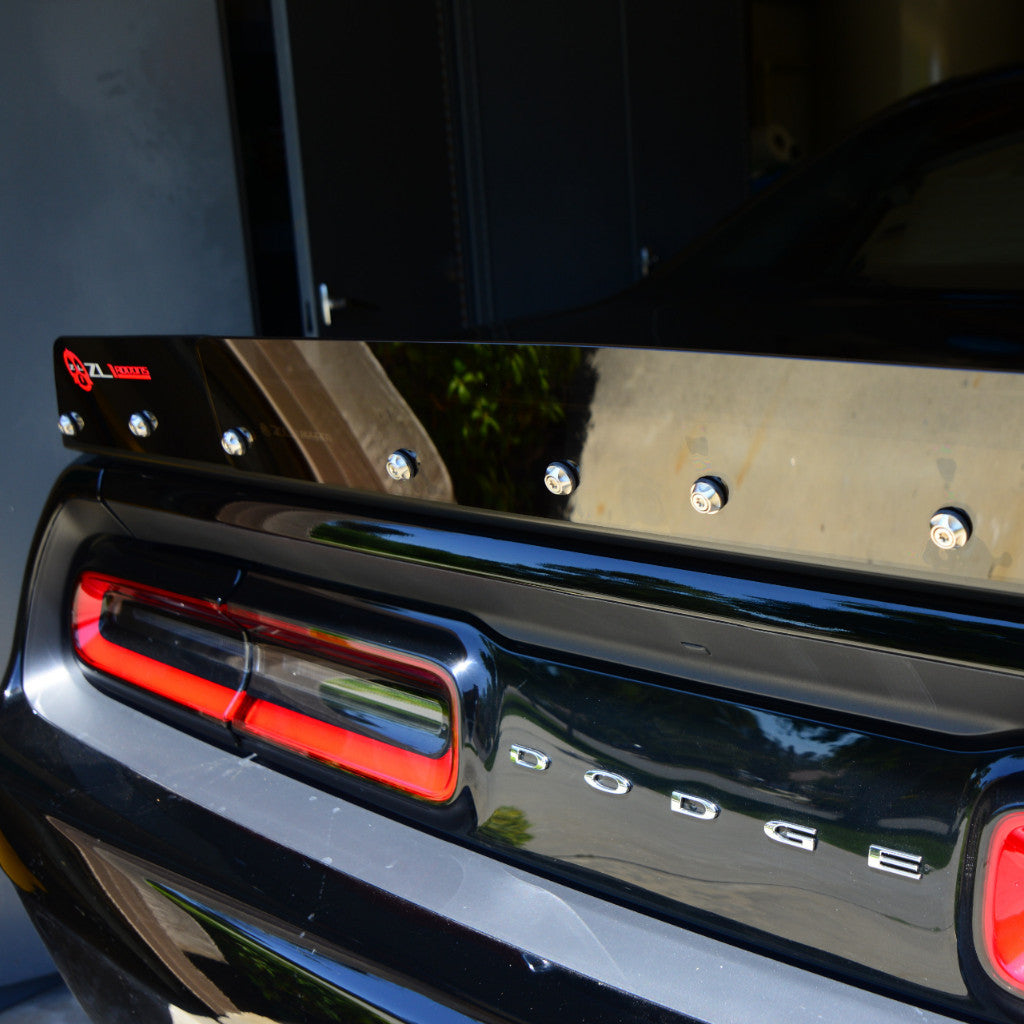 Close-up of a black Dodge vehicle tailgate with a red accent light.